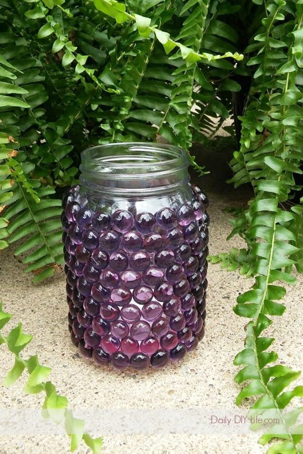 Whimsical DIY Mason Jar Luminaries will light up any outdoor space. If you are looking for a quick and easy craft to spruce up the patio, look no further. You may even have all of the materials already, and if you don't, your local dollar tree will have everything you need. #DIYGardenCrafts #DollarTreeCrafts #DollarStoreCrafts #SimpleDIY #OutdoorDecor #MasonJarCrafts #MasonJars 