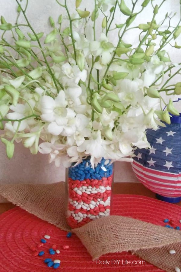 Craft your love for the Red White & Blue with this easy DIY Patriotic Mason Jar craft. Add a stunning bouquet of fresh cut flowers and you have the perfect addition to your holiday decor! 