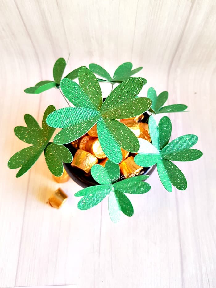 Looking for an Easy Cricut Craft for St. Patricks Day? These adorable DIY Paper Four Leaf Clovers will add just the right touch to your decor or next craft project. A simple project for any Cricut machine. #CricutMade #EasyCricutCraft #StPatricksDayCraft #DIYPaperCrafts