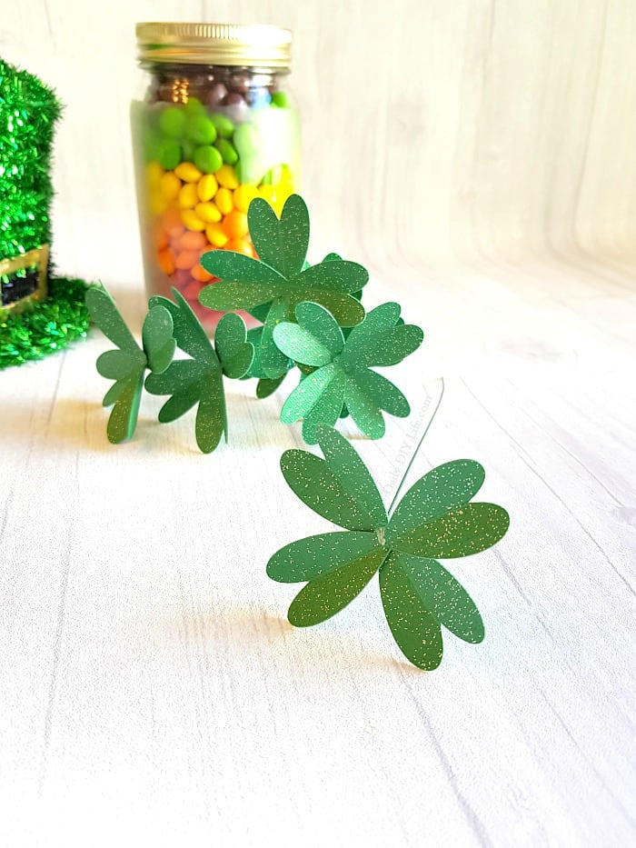 Looking for an Easy Cricut Craft for St. Patricks Day? These adorable DIY Paper Four Leaf Clovers will add just the right touch to your decor or next craft project. A simple project for any Cricut machine. #CricutMade #EasyCricutCraft #StPatricksDayCraft #DIYPaperCrafts