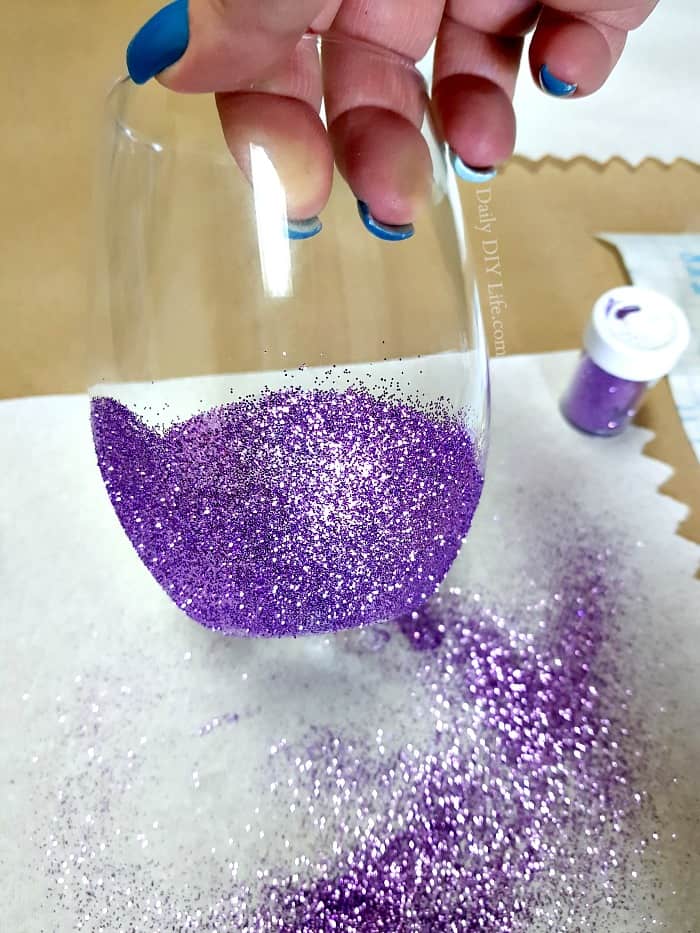 Create your own colorful and fun Glitter Wine Glasses right at home for a fraction of the cost of one in a specialty store. A fun easy DIY Cricut Project that will bring out your inner magical mermaid. Let's face it, everything is better with glitter and mermaid magic! #CricutMade #CraftAndCreateWithCricut #CricutDIY #GlitterGlasses #DIYWineGlasses #CustomGlasses #GlitterModPodge #ModPodge #BlingDIY