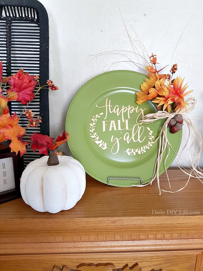 This Easy Fall Decor Project is the perfect piece to add to your Fall decorating. Using a Dollar Tree charger, silk flowers and your Cricut, you can create a custom design that will match your own design style. This beautiful piece can be done in less than a day from start to finish. #CricutMade #CraftAndCreateWithCricut #Cricut #Vinyl #VinylStencil #DIYFall #FallDecor #FallDecorating