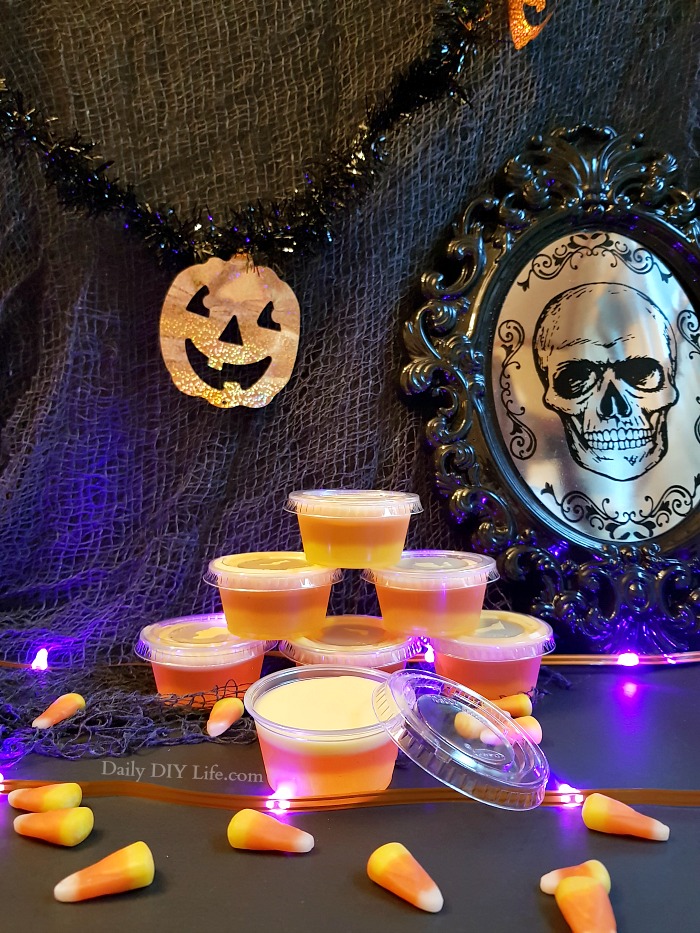 Grown-ups need a trick or treat too! These Candy Corn Jello Shots are a whimsical treat for the adults looking to bring out their inner child. Sweet, strong and potent, just the right kick for all the grown-ups this Halloween. Enjoy Responsibly! #Cocktails #FallCocktails #CandyCornDrinks #JelloShots #AdultBeverages #HalloweenCocktails