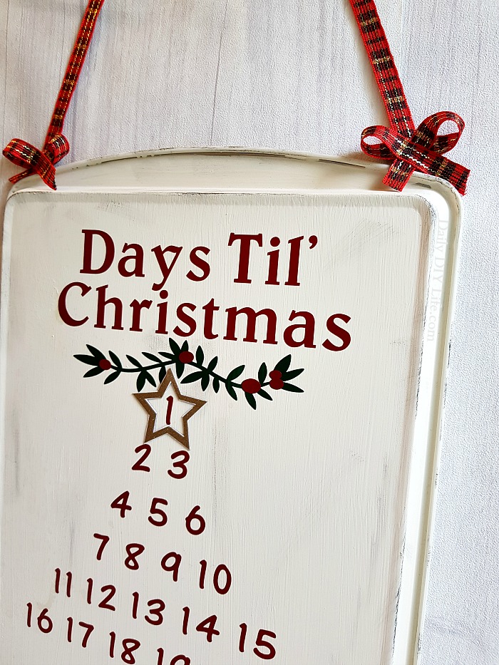 This Rustic Farmhouse Style Advent Calendar is the perfect addition to your holiday decor. An easy Dollar Tree DIY craft that you can make in one day. Using StyleTech Craft Vinyl and your cutting machine, this Christmas Countdown Advent Calendar will look great with any decor. #Sponsored #ChristmasDIY #AdventCalendar #ChristmasCountdown #Styletechcraft #Vinyl #GlossyVinyl #ChristmasCrafts