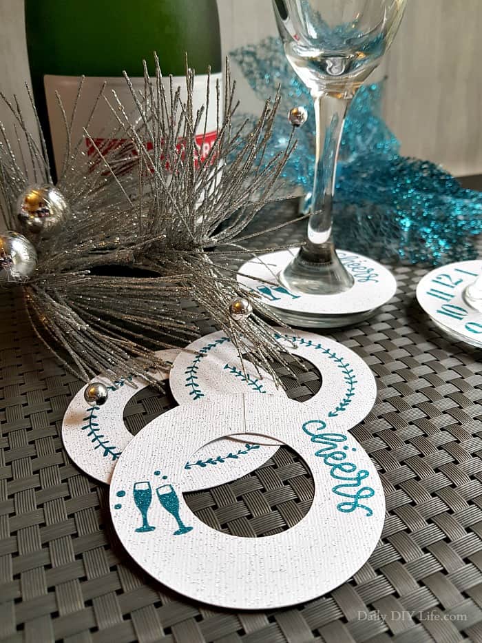 Add a little glitz and glam to your New Years Eve celebration with these easy DIY Paper Champagne Glass Tags. A little extra sparkle is always welcome on New Years Eve. These fun tags are quick to make and can be completely customized using your Cricut or Silhouette cutting machine. #Sponsored #Styletechcraft #StyleTech #StyleTechCraftVinyl #Cricut #CricutMade #CricutProjects #VinylProjects #GlitterVinyl #UltraMetallic #UltraGlitter #NYECrafts #NewYearsEve