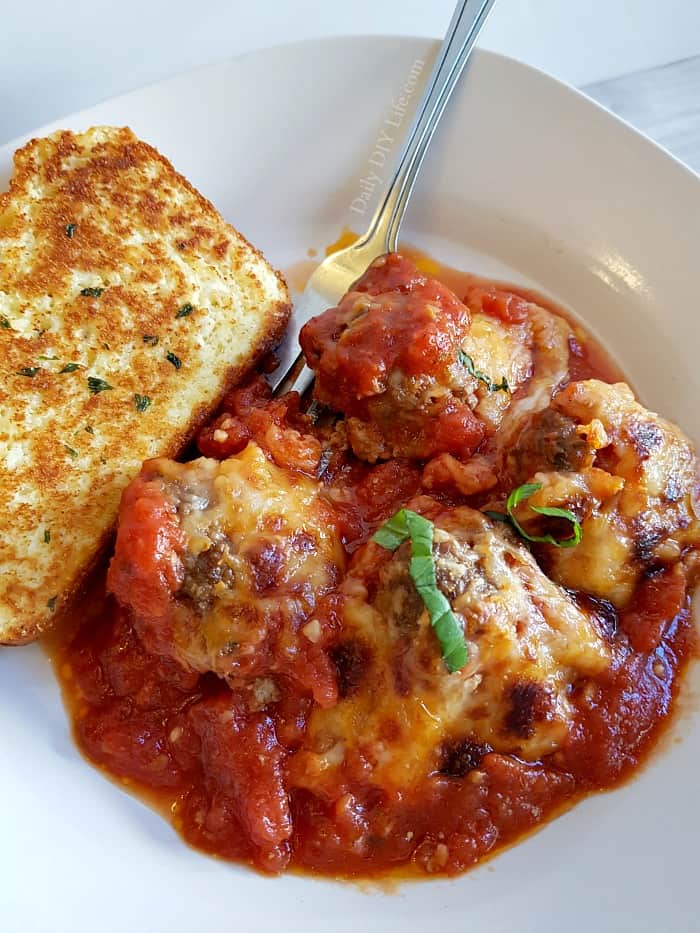 Smothered in a savory homemade marinara sauce, these cheesy baked meatballs are full of flavor and a satisfying keto friendly dinner. Paired with a fresh green salad or low carb bread for a complete meal. With the right ingredients, low carb high-fat cooking doesn't have to be boring or complicated. #LCHF #Keto #KetoRecipes #KetoCooking #EasyKetoMeals #SkilletMeals 
