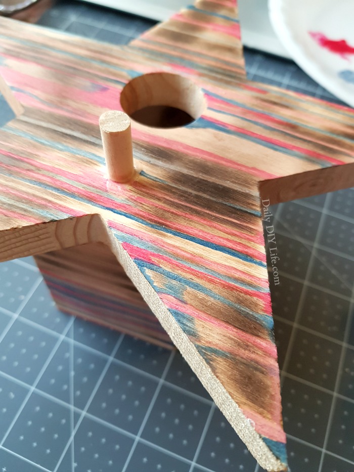 If you are a fan of unique DIY paint techniques, then you are going to love the Rustic Wood Stain on this Birdhouse. Using a fun patriotic color palette, I decorated a raw wood birdhouse using DecoArt Americana Decor Colorstain in various shades of reds, white, and blues. This technique can be a bit tedious, but the end result is beautiful. You won't regret giving it a try.  #Sponsored #DecoArt #PaintTechnique #DIYPaintProjects #PaintByNumber #WoodPainting