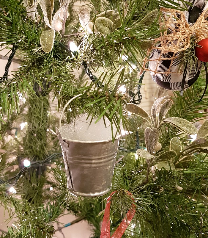 Farmhouse Style Christmas Ornaments that won't break the bank. These mini galvanized buckets are the perfect addition to your farmhouse Christmas tree. Using supplies from the dollar tree, your Cricut cutting machine, and some glossy StyleTech Craft vinyl, you can customize each one with your favorite farmhouse saying. We all need a little fresh now at Christmas! #Sponsored #StyleTechCraft #StyleTech #GlossyVinyl #CricutMade #CricutChristmasCrafts #DIYChristmas #FarmhouseChristmas #DIYFarmhouseChristmas
