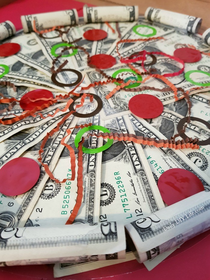 Making the perfect DIY Money Gift for the person that has everything is not only fun and easy, it is also a really cool way to give the gift of cash in a unique way. A few basic supplies, some dollar bills and a little bit of your time and you have a creative gift that everyone will want to receive. You can't go wrong with cash, am I right? #StyleTechCraft #StyleTechCraftVinyl #GlossyVinyl #CricutMade #Cricut #MoneyGiftIdea #DIYGiftIdeas #DIYPizza #DIYVinylCraft #MoneyGiftIdeas