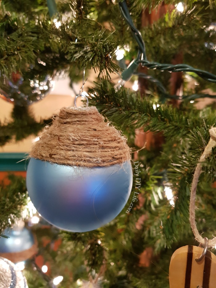 Beautiful Coastal Christmas Ornaments in a lovely sea blue with rustic natural twine are just the right touch to bring a bit of the beach to your holiday tree this year. Using simple supplies from the Dollar Tree, you can have these rustic elegant Christmas bulbs made in no time. If you are a lover of all things coastal, or beach decor at the holidays, you are going to love making these. #DollarTreeChristmas #CoastalChristmas #ChristmasOrnamentsDIY #DIYChristmas #DIYCoastalChristmas #CoastalChristmasCrafts #ChristmasDIYOrnaments #SeaBlueDecor #DIYChristmasCraft
