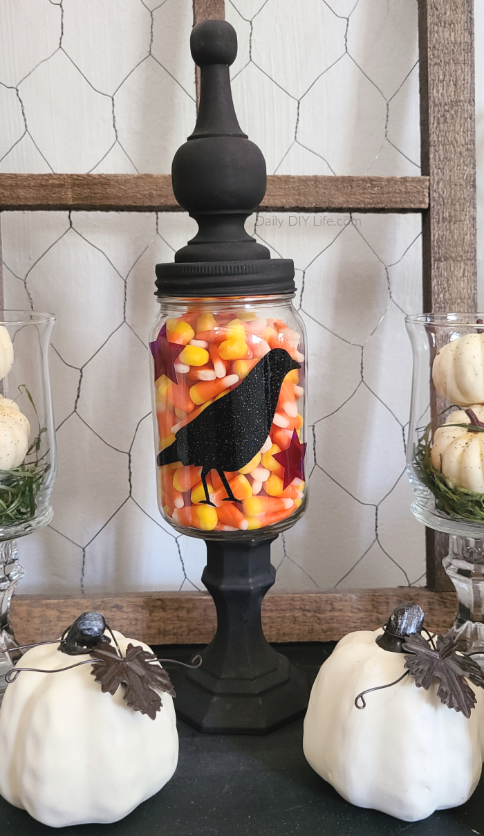 This Primitive Fall Mason Jar can be used for candy and sweet treats, or you can add some twinkle lights to set the right mood. A simple DIY using a mason jar and some fun vinyl cutouts only add to its character. You will be surprised just how easy this adorable Fall Mason Jar is to put together. #Sponsored #StyleTechCraft #StyleTech #VinylCrafts #TransparentVinyl #CricutMade #Cricut #PrimitiveCrafts #PrimDiy #MasonJarCrafts #MasonJarDIY