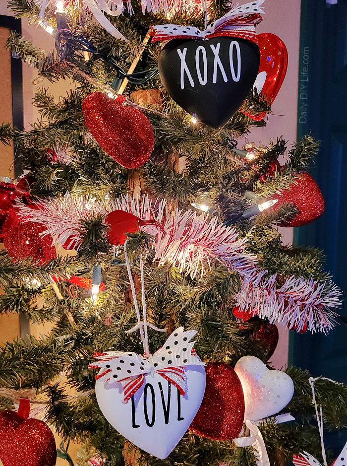 If you are a fan of the adorable and super trendy Rae Dunn Decor, you are going to love these DIY Dollar Tree Valentine's Day Ornaments. Using items from your local Dollar Tree, you can personalize just about anything. With a little paint and some vinyl cut with your Cricut, you can have these fun Valentine's Day Ornaments done in no time. #DollarTreeDivas #DollarTreeCrafts #CricutMade #Cricut #RaeDunnInspired #ValentinesDaysDollarTree #DollarTreeDIY 
