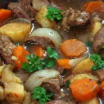 closeup of mulligan stew in bowl with parsley