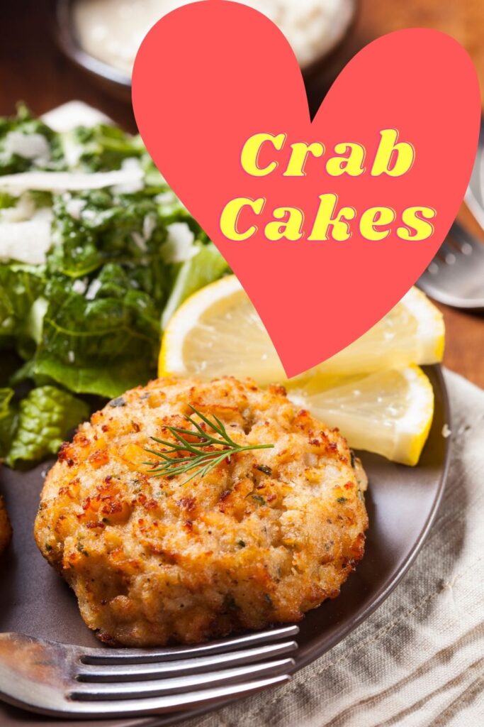 crab cake on plate with fork and lemon