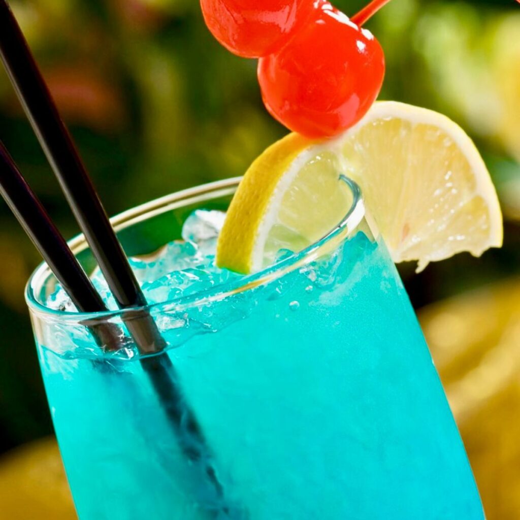 blue motorcycle drink recipe with cherry and lemon wedge