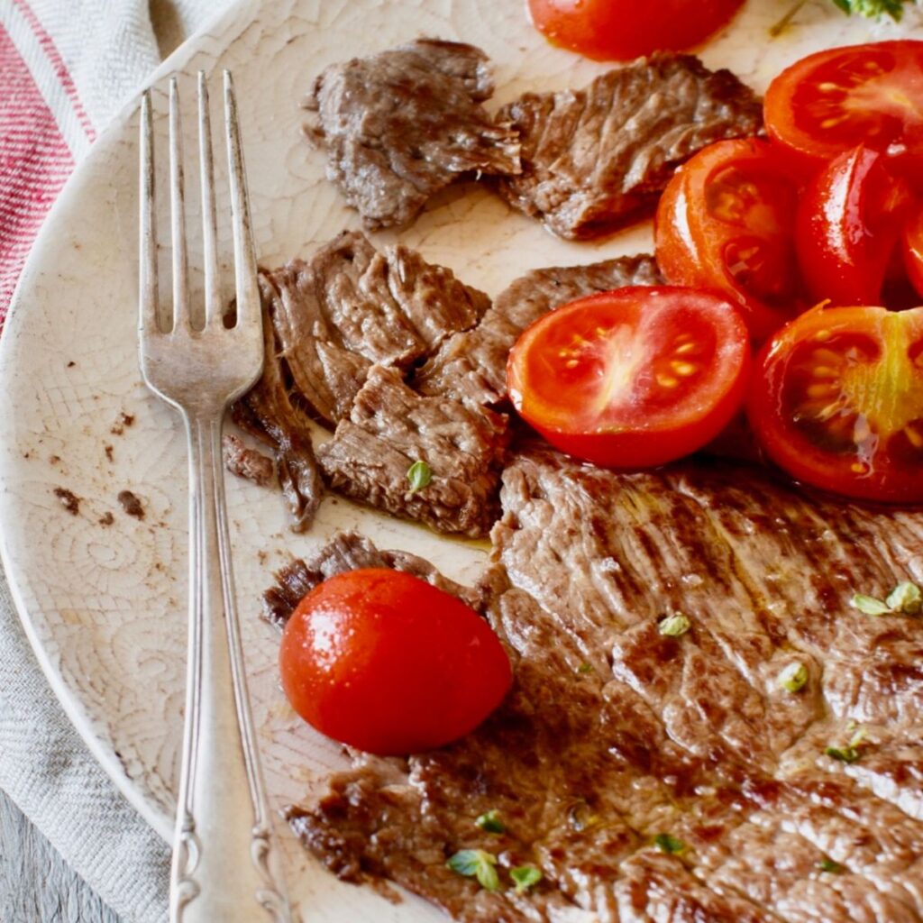 sizzle steak with tomatoes on plate