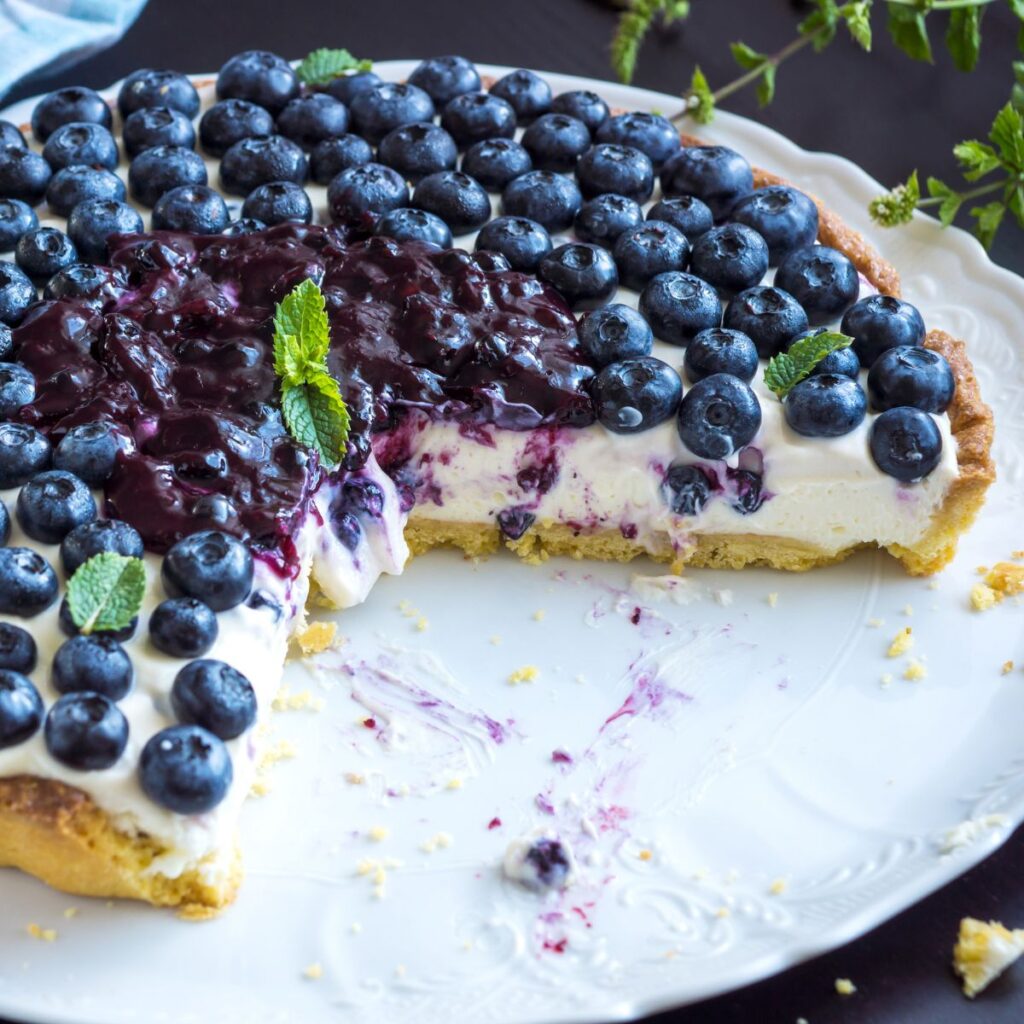 Blueberry Custard Cream Pie With a Slice Cut out