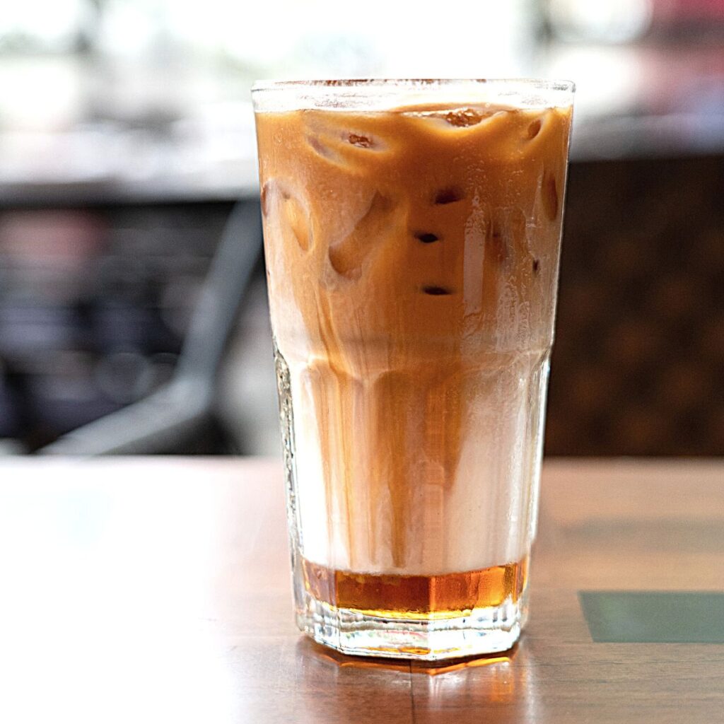 A cup of Iced Caramel Macchiato on a table