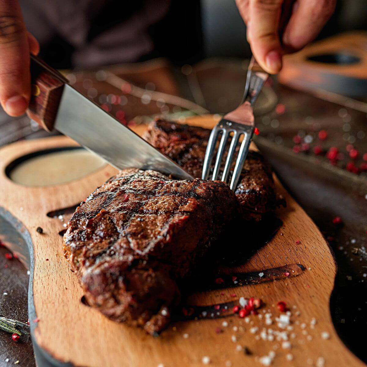 texas roadhouse steak being cut into