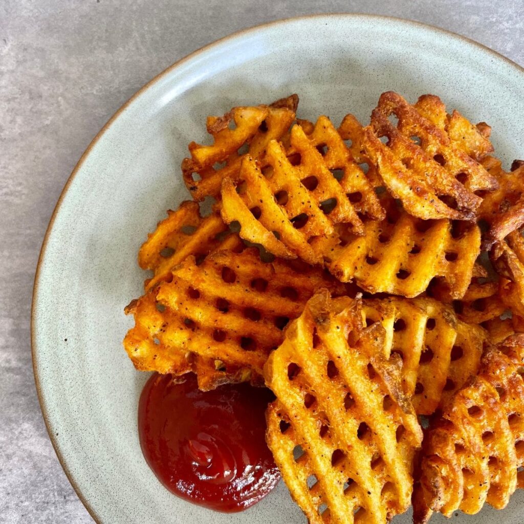 frozen waffle fries air fryer with a side of ketchup