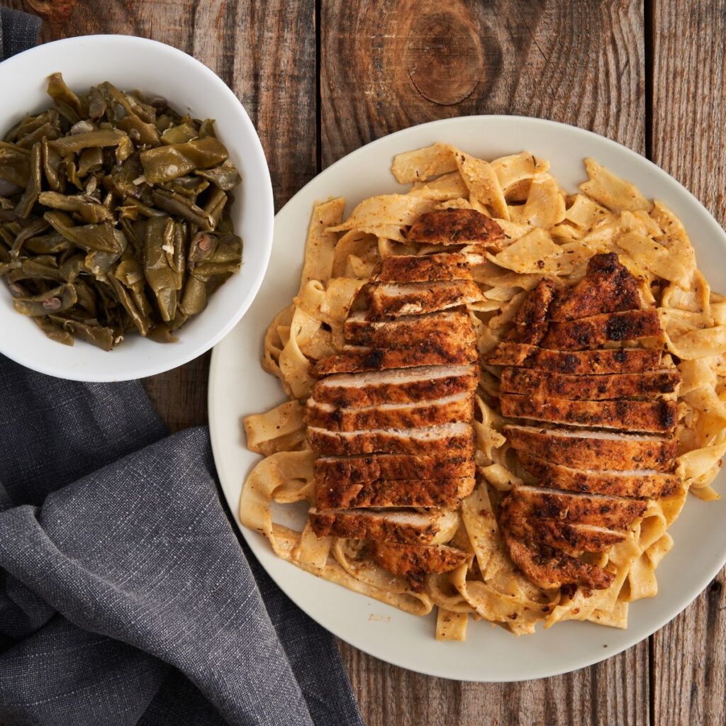 blackened chicken on fettuccini with side of collard greens