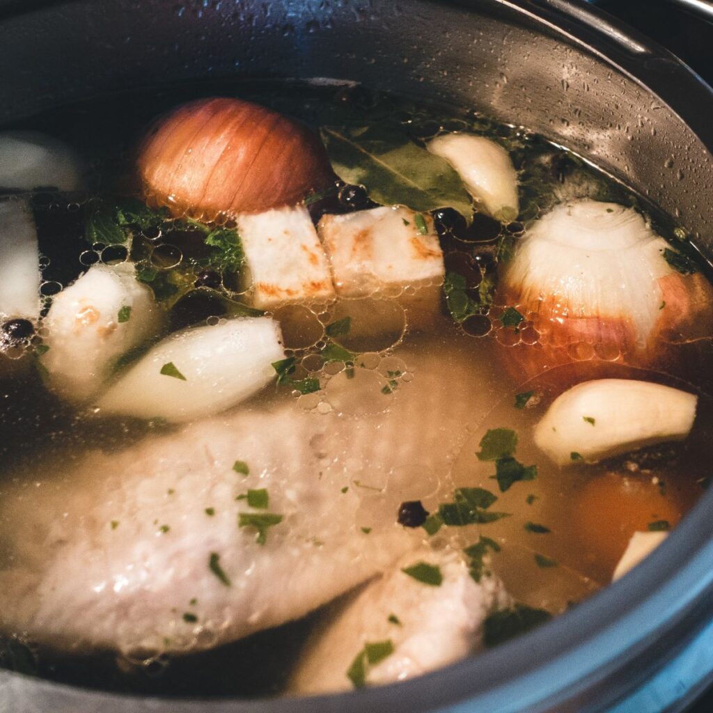 boiling a whole chicken in a large pot