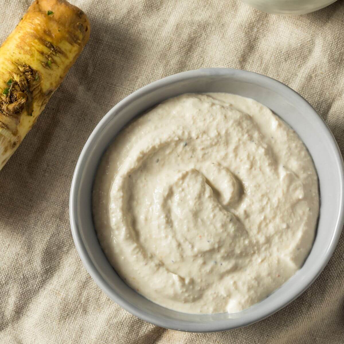 tiger sauce on burlap with raw horseradish