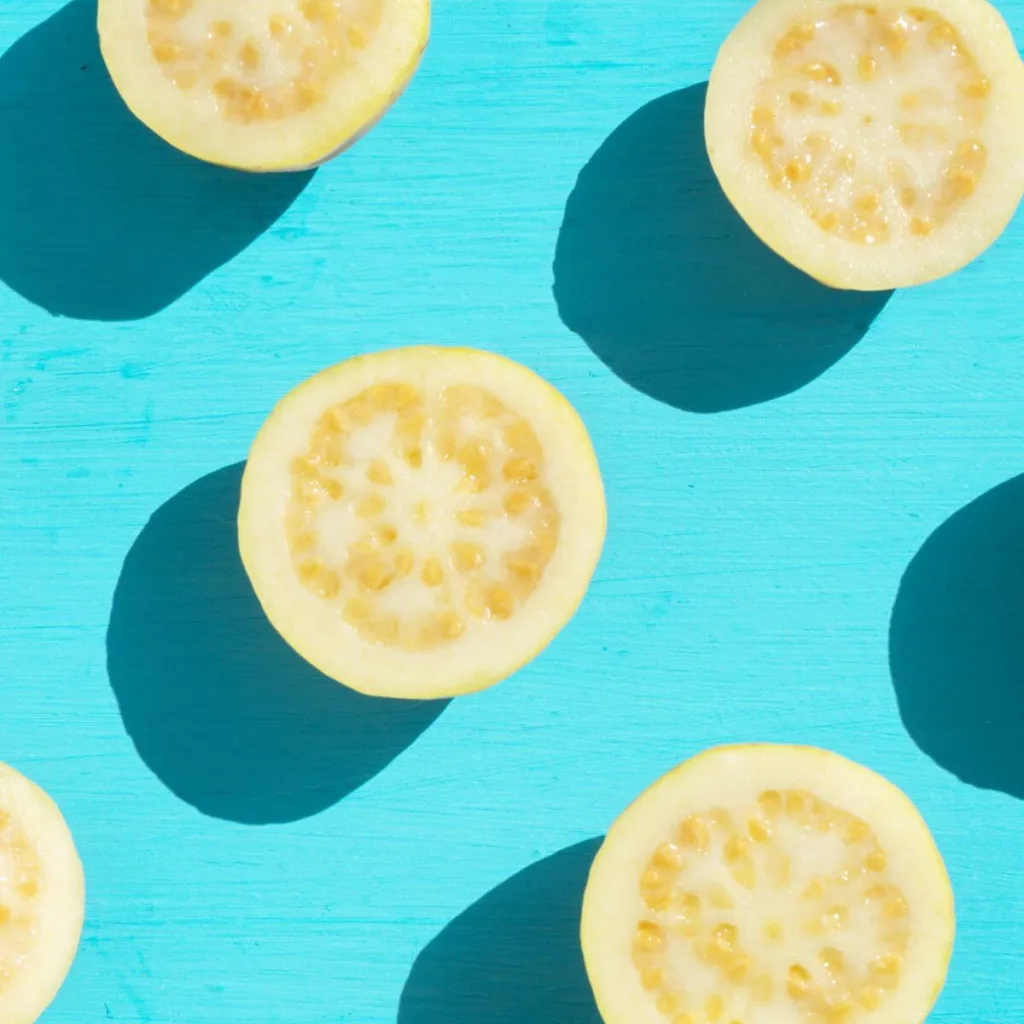 slices of yellow guava on blue background