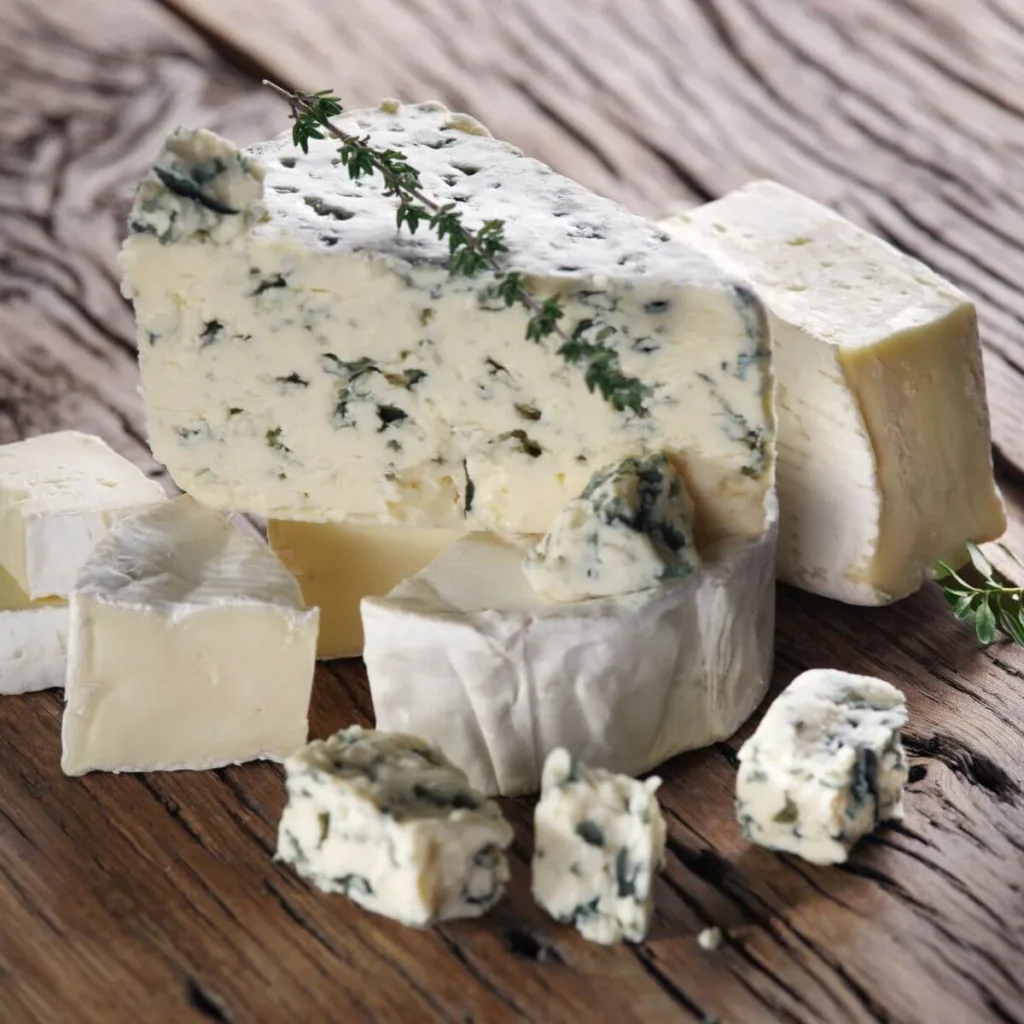 hunk of blue cheese surrounded by brie