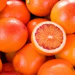 pile of blood oranges with one sliced open