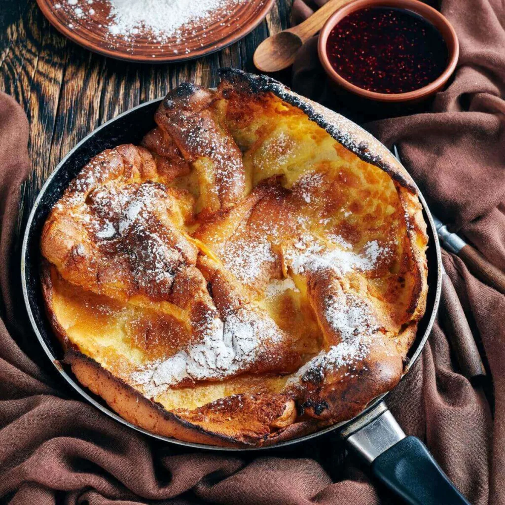 top view of a dutch baby pancake with powdered sugar