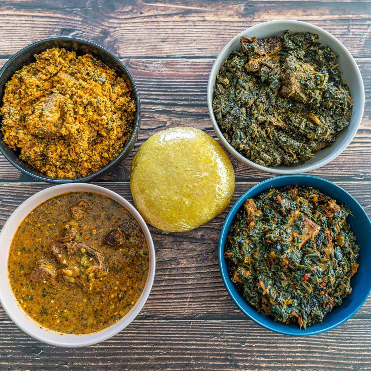 a nigerian swallow surrounded by stews and soups