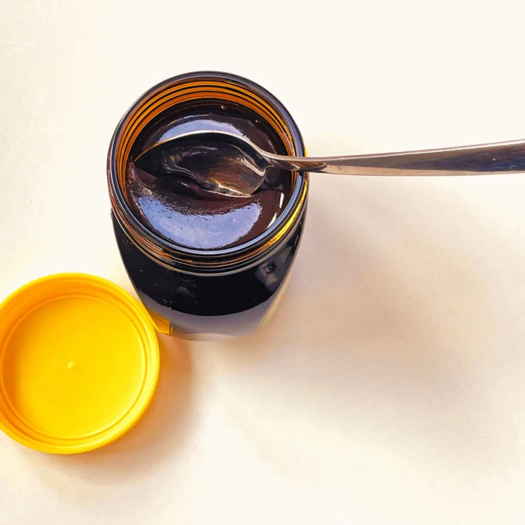 jar of open marmite with small spoon