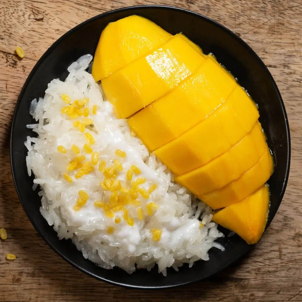 ripe mango in a bowl with sticky rice