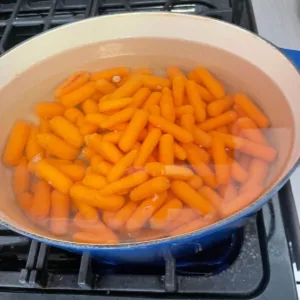 baby carrots in pot of water