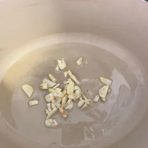 chopped cloves of garlic in Dutch oven