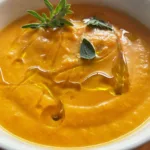cream of carrot soup with herbs and olive oil