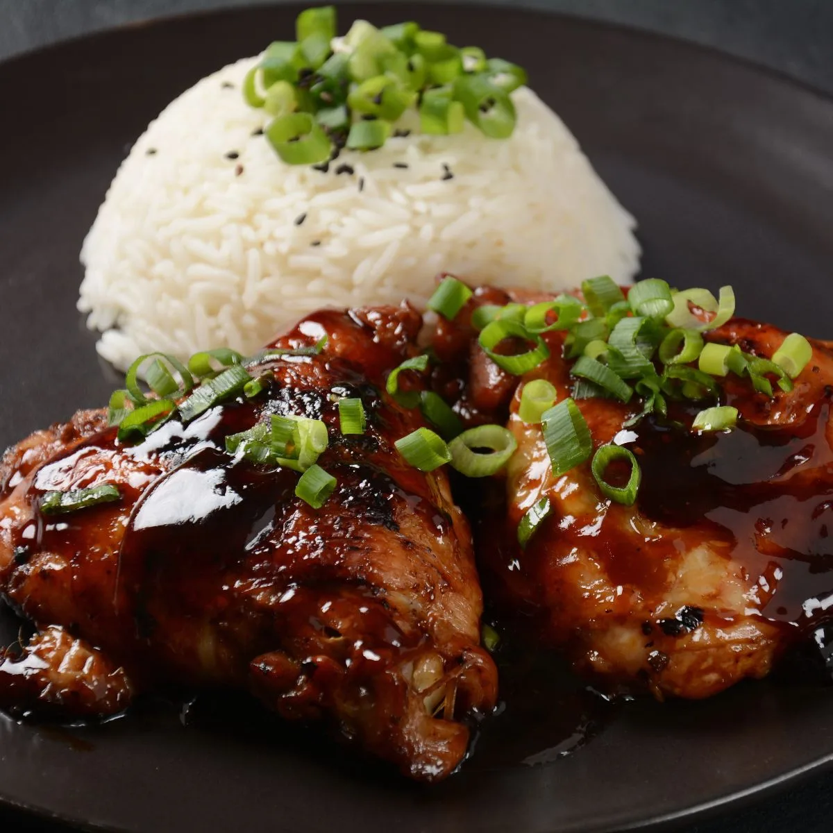 Chicken thighs cooked in adobo sauce with rice